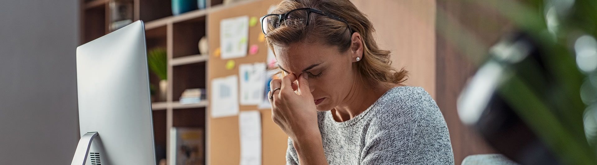 woman using computer stressed at work 