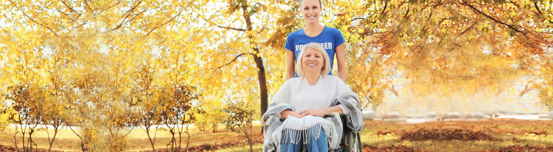 volunteer with woman in wheelchair